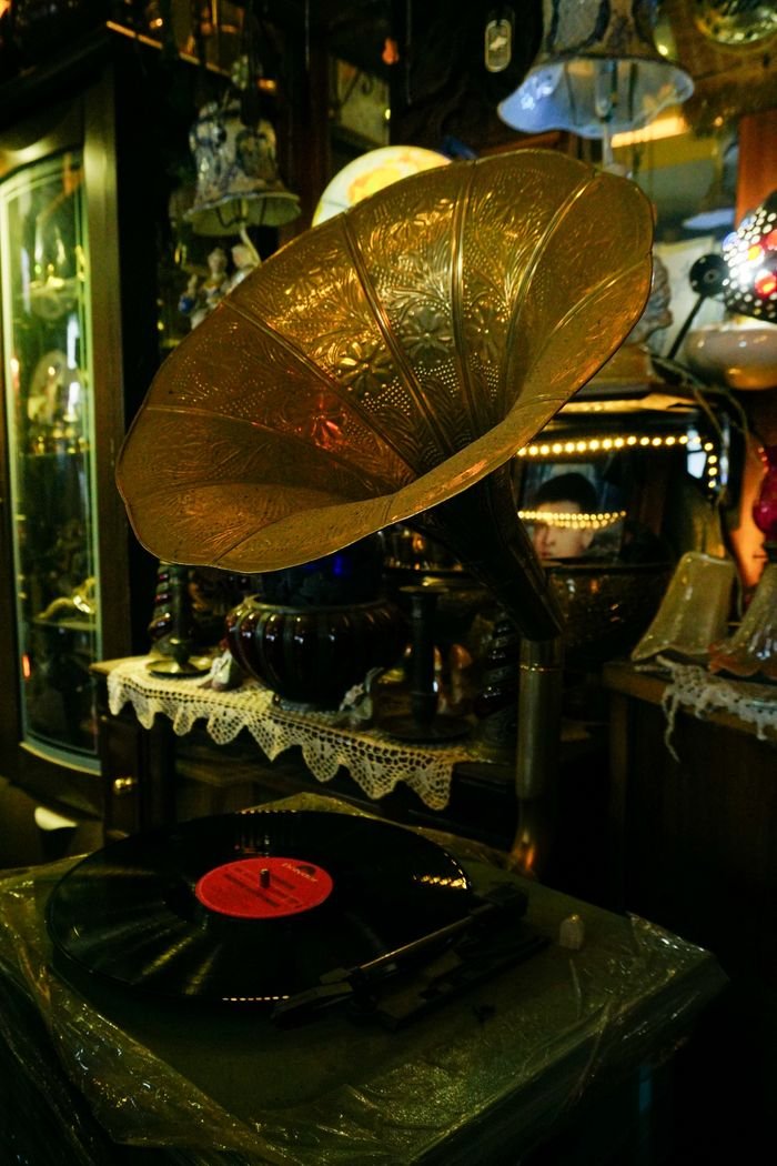 bedroom-bliss A beautiful vintage gramophone and vinyl record displayed in a charming antique shop setting.